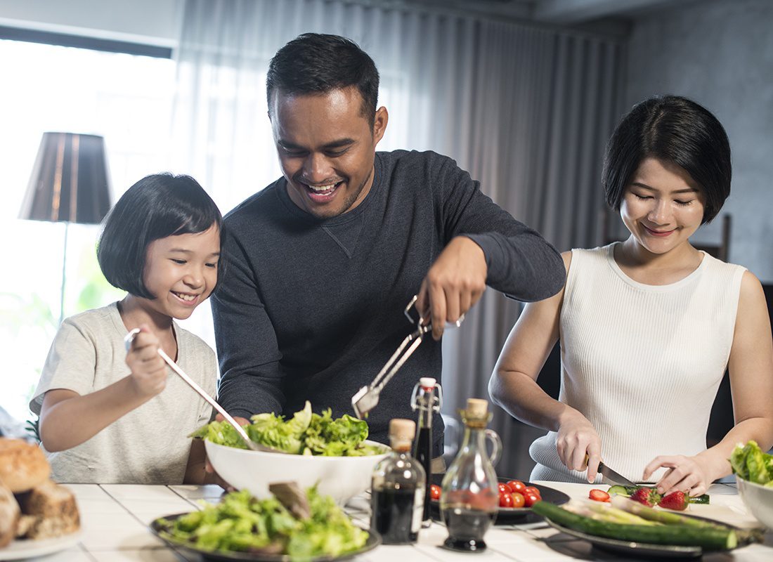 Personal Insurance - Happy Family Prepares Salad Together at Home